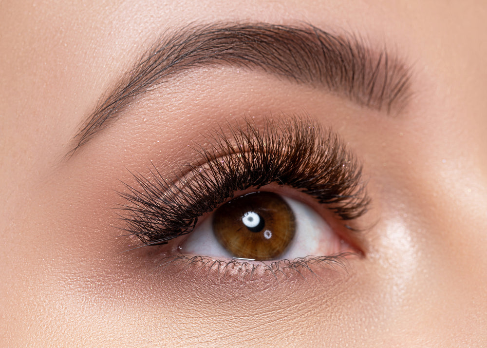 Close-up of beautifully applied lash extensions enhancing a natural eye makeup look